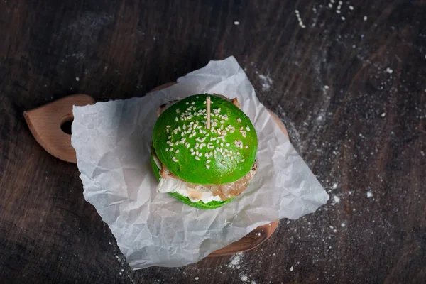 green home made burger on dark blue background