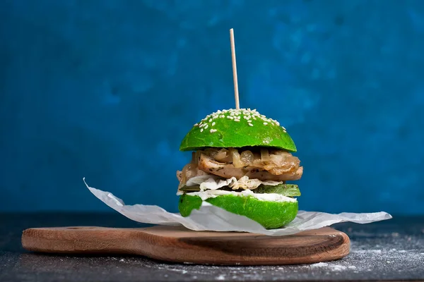 green home made burger on dark blue background