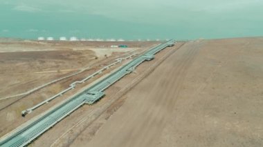 Industrial gas pipes among fields. Top view. 4K
