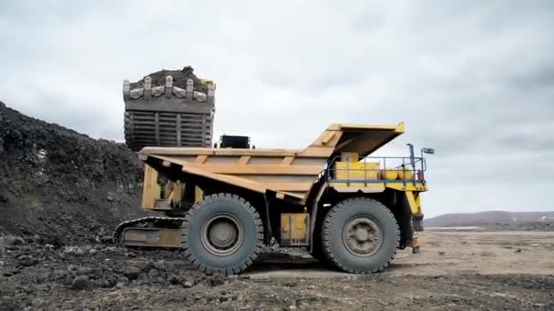 Large Yellow Truck Drives Excavator Soil Sand Loaded Wide Shot — Vídeos de Stock