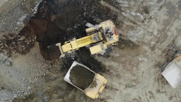 Top View Yellow Excavator Loading Ore Dump Truck Drone Flies — Wideo stockowe