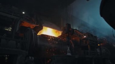 Molten metal in a metallurgical furnace. Sparks splatter from the furnace. Liquid metal production process. Metallurgy.4K
