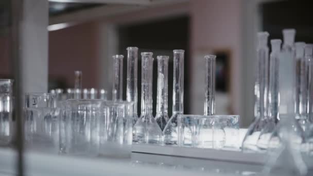 Laboratory Misted Glass Flasks Measuring Cups Vertical Panorama Focus Shifts — Video Stock