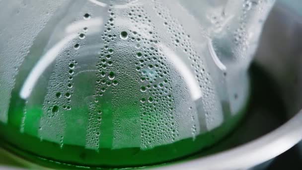 Green Liquid Misted Glass Flask Close Small Bubbles Appear Flask — Vídeos de Stock