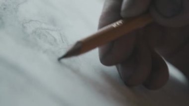 Artist quickly shading with pencil on paper. Close-up of a hand. Pencil drawing. Creative process. Art. 4K