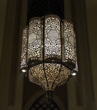 Beautiful  Islamic architecture design chandelier with lights glowing on the ceiling 