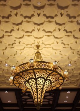 beautiful gold pattern design chandelier on the gold pattern ceiling  
