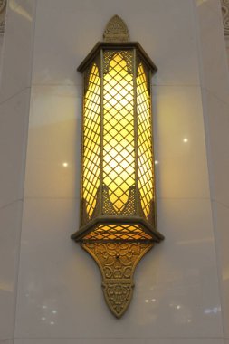 beautiful Islamic design lantern glowing on the wall 