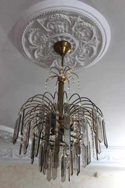 beautiful chandelier inside the home with a gold covering