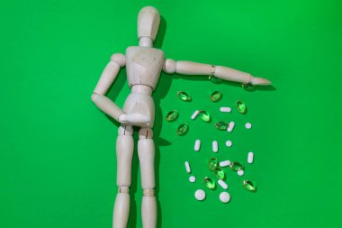 The dangers of Drug overdose concept, symbolized by an anonymous wooden mannequin. green screen 