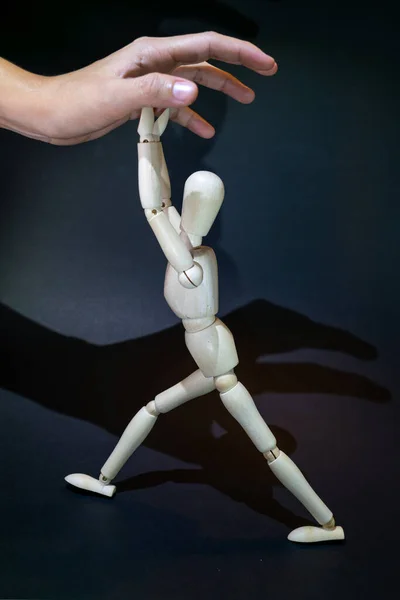 Wooden Dummy Fights Human Hand Tryingto Grasp Black Background — Foto Stock