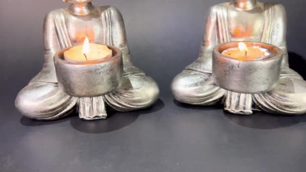 Two Buddhas Burning Candles Black Background — Stok Video