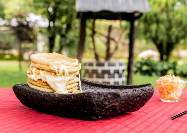 typical Salvadoran dish, cheese pupusas with cabbage and tomato sauce. rice and corn pupusas stuffed with cheese, beans or other ingredients