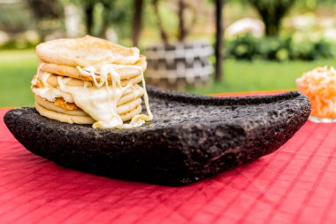typical Salvadoran dish, cheese pupusas with cabbage and tomato sauce. rice and corn pupusas stuffed with cheese, beans or other ingredients