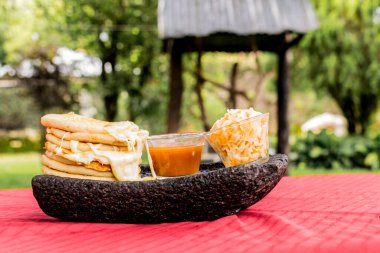 typical Salvadoran dish, cheese pupusas with cabbage and tomato sauce. rice and corn pupusas stuffed with cheese, beans or other ingredients