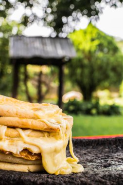 typical Salvadoran dish, cheese pupusas with cabbage and tomato sauce. rice and corn pupusas stuffed with cheese, beans or other ingredients