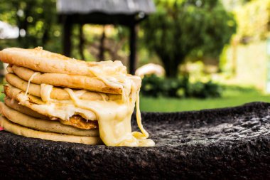 typical Salvadoran dish, cheese pupusas with cabbage and tomato sauce. rice and corn pupusas stuffed with cheese, beans or other ingredients