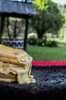 typical Salvadoran dish, cheese pupusas with cabbage and tomato sauce. rice and corn pupusas stuffed with cheese, beans or other ingredients