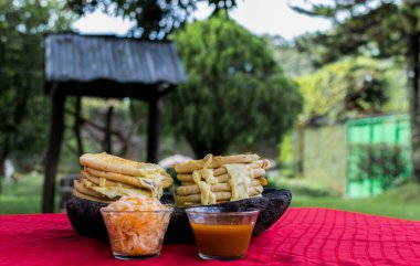 typical Salvadoran dish, cheese pupusas with cabbage and tomato sauce. rice and corn pupusas stuffed with cheese, beans or other ingredients