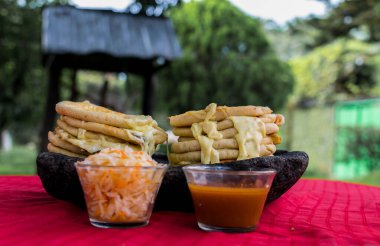 typical Salvadoran dish, cheese pupusas with cabbage and tomato sauce. rice and corn pupusas stuffed with cheese, beans or other ingredients