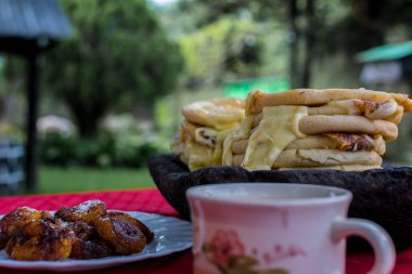 typical Salvadoran dish, cheese pupusas with cabbage and tomato sauce. rice and corn pupusas stuffed with cheese, beans or other ingredients