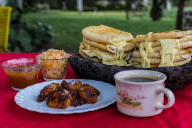 typical Salvadoran dish, cheese pupusas with cabbage and tomato sauce. rice and corn pupusas stuffed with cheese, beans or other ingredients
