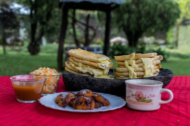 typical Salvadoran dish, cheese pupusas with cabbage and tomato sauce. rice and corn pupusas stuffed with cheese, beans or other ingredients