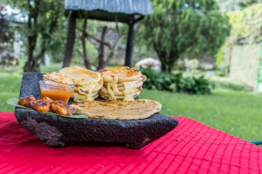 typical Salvadoran dish, cheese pupusas with cabbage and tomato sauce. rice and corn pupusas stuffed with cheese, beans or other ingredients