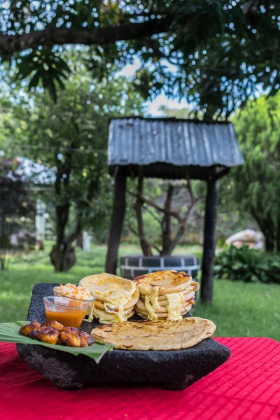 typical Salvadoran dish, cheese pupusas with cabbage and tomato sauce. rice and corn pupusas stuffed with cheese, beans or other ingredients