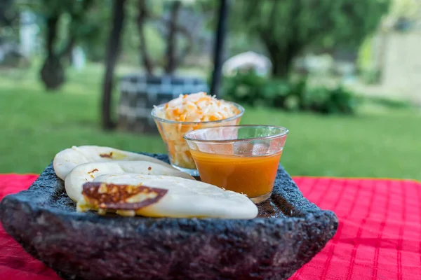 typical Salvadoran dish, cheese pupusas with cabbage and tomato sauce. rice and corn pupusas stuffed with cheese, beans or other ingredients