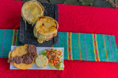 typical Salvadoran dish, cheese pupusas with cabbage and tomato sauce. rice and corn pupusas stuffed with cheese, beans or other ingredients