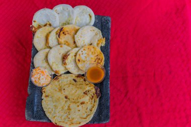 typical Salvadoran dish, cheese pupusas with cabbage and tomato sauce. rice and corn pupusas stuffed with cheese, beans or other ingredients
