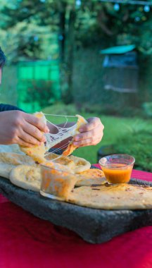 typical Salvadoran dish, cheese pupusas with cabbage and tomato sauce. rice and corn pupusas stuffed with cheese, beans or other ingredients