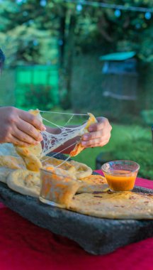 typical Salvadoran dish, cheese pupusas with cabbage and tomato sauce. rice and corn pupusas stuffed with cheese, beans or other ingredients