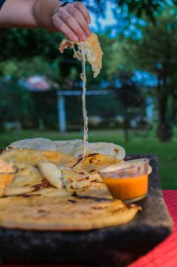typical Salvadoran dish, cheese pupusas with cabbage and tomato sauce. rice and corn pupusas stuffed with cheese, beans or other ingredients