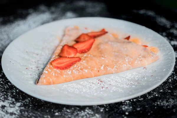 delicious crepe with strawberries top view