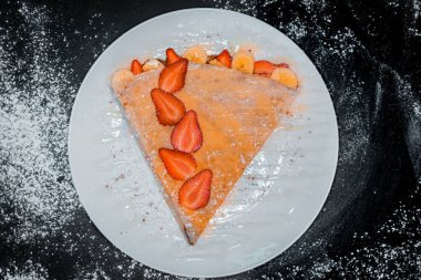 delicious crepe with strawberries top view