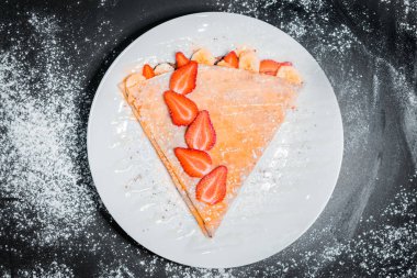 delicious crepe with strawberries top view