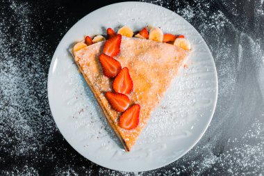 delicious crepe with strawberries top view