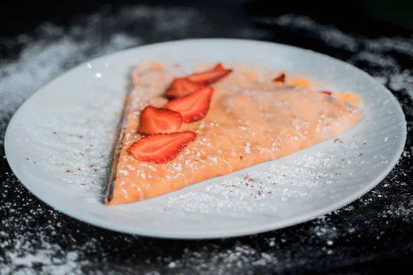 delicious crepe with strawberries top view