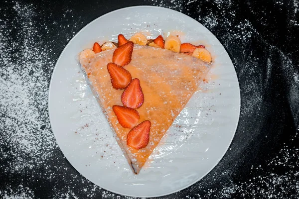 delicious crepe with strawberries top view