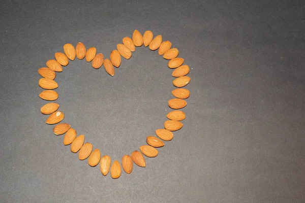 almond seeds forming a heart. healthy nutrition