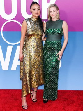 Australian actress Aisha Dee and American actress Lili Reinhart wearing Miu Miu arrive at the Los Angeles Premiere Of Netflix's 'Look Both Ways' held at the Netflix Tudum Theater on August 16, 2022 in Hollywood, Los Angeles, California, United States