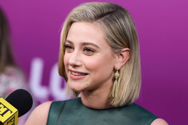 American actress Lili Reinhart wearing Miu Miu is interviewed by Entertainment Tonight (ET) at the Los Angeles Premiere Of Netflix's 'Look Both Ways' held at the Netflix Tudum Theater on August 16, 2022 in Hollywood, Los Angeles, California