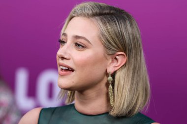 American actress Lili Reinhart wearing Miu Miu is interviewed by Entertainment Tonight (ET) at the Los Angeles Premiere Of Netflix's 'Look Both Ways' held at the Netflix Tudum Theater on August 16, 2022 in Hollywood, Los Angeles, California