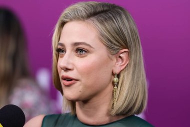 American actress Lili Reinhart wearing Miu Miu is interviewed by Entertainment Tonight (ET) at the Los Angeles Premiere Of Netflix's 'Look Both Ways' held at the Netflix Tudum Theater on August 16, 2022 in Hollywood, Los Angeles, California