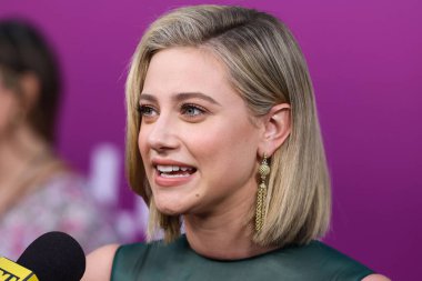 American actress Lili Reinhart wearing Miu Miu is interviewed by Entertainment Tonight (ET) at the Los Angeles Premiere Of Netflix's 'Look Both Ways' held at the Netflix Tudum Theater on August 16, 2022 in Hollywood, Los Angeles, California
