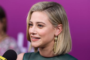 American actress Lili Reinhart wearing Miu Miu is interviewed by Entertainment Tonight (ET) at the Los Angeles Premiere Of Netflix's 'Look Both Ways' held at the Netflix Tudum Theater on August 16, 2022 in Hollywood, Los Angeles, California