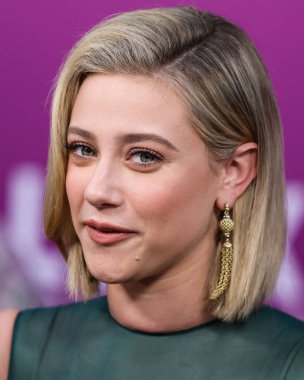 American actress Lili Reinhart wearing Miu Miu is interviewed by Entertainment Tonight (ET) at the Los Angeles Premiere Of Netflix's 'Look Both Ways' held at the Netflix Tudum Theater on August 16, 2022 in Hollywood, Los Angeles, California