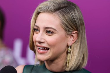 American actress Lili Reinhart wearing Miu Miu is interviewed by Entertainment Tonight (ET) at the Los Angeles Premiere Of Netflix's 'Look Both Ways' held at the Netflix Tudum Theater on August 16, 2022 in Hollywood, Los Angeles, California